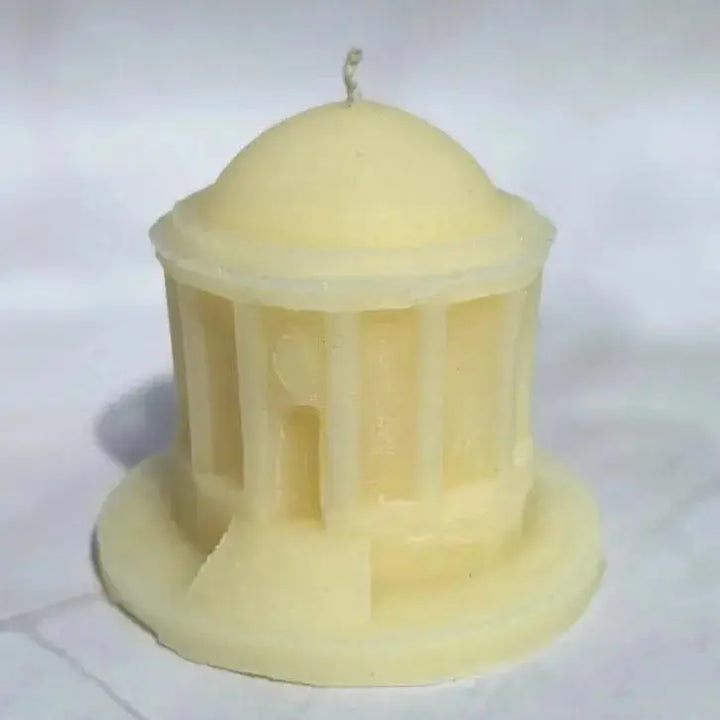 Cream beeswax candle shaped like Mussenden Temple, a domed round temple with columns